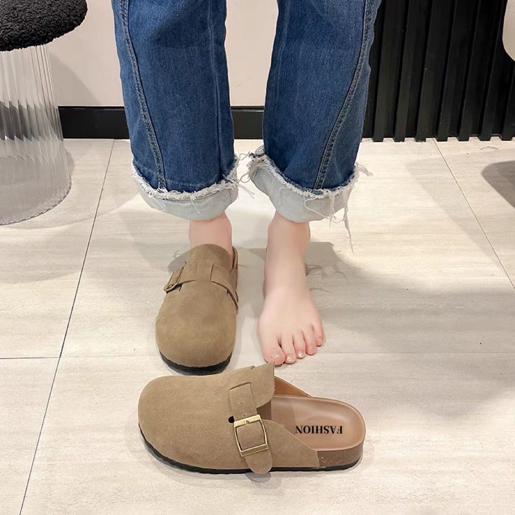 Half a slipper and one foot on lazy trendy shoes