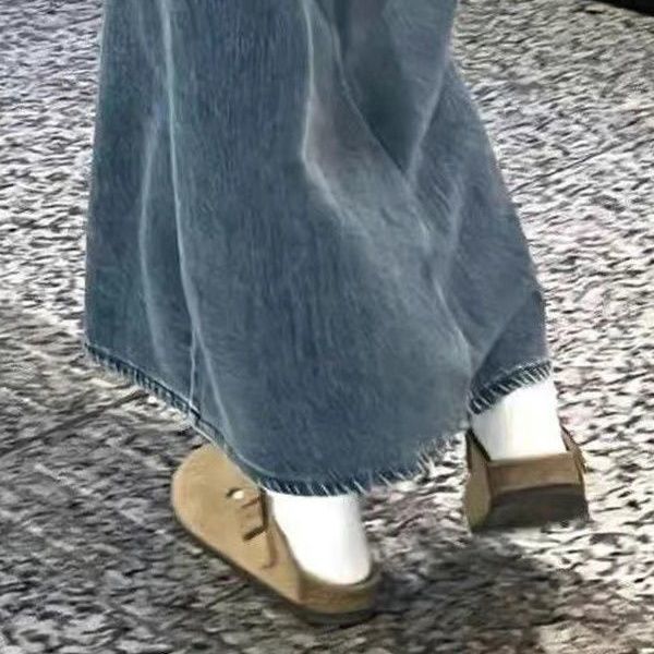 Half a slipper and one foot on lazy trendy shoes