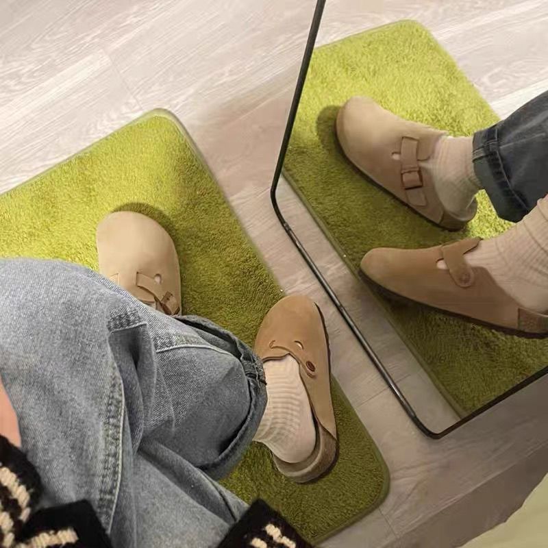 Half a slipper and one foot on lazy trendy shoes