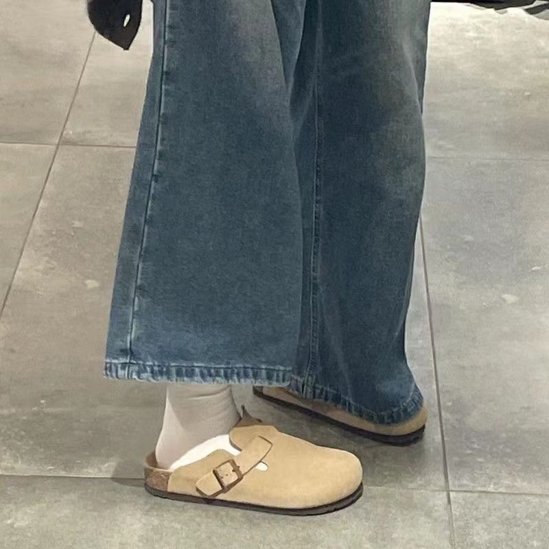 Half a slipper and one foot on lazy trendy shoes